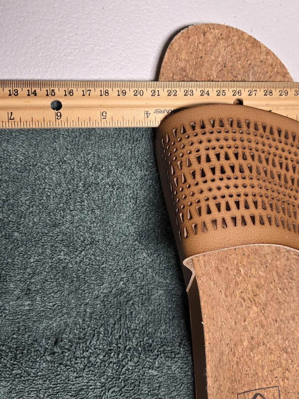 Reef women's comfort slide sandals featuring a soft cork footbed and perforated